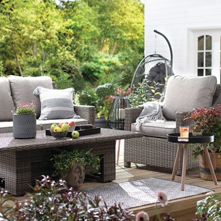 Grey rattan furniture in a beautifully decorated patio.