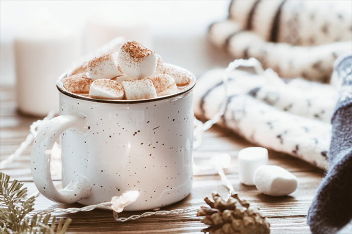 Cup of hot chocolate with chunky marshmallows and a cocoa dusting