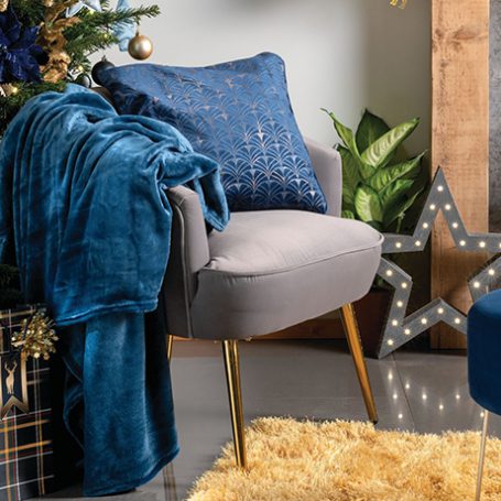 Living room at Christmas time decorated in dark blues and gold