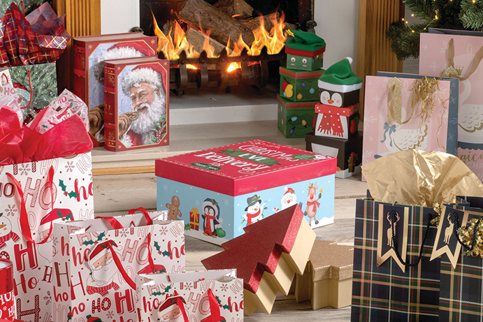 Varitety of Christmas gift boxes and gift bags in a living room decorated for Christmas