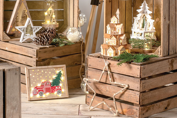 Wooden crates with illuminated scandi style christmas decorations on