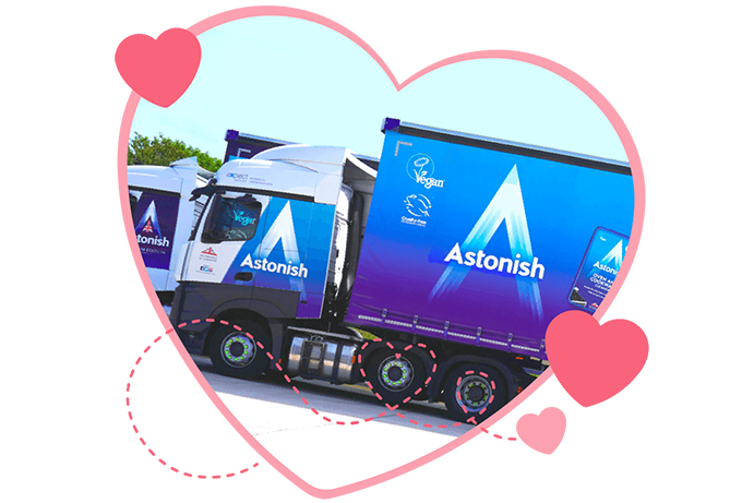 Astonish branded lorry on the road in a heart shape frame.
