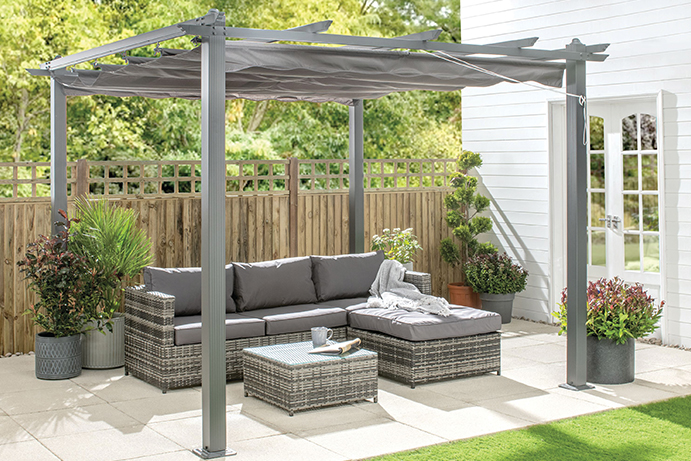 Large L-shape outdoor sofa on a patio covered by a charcoal pergola