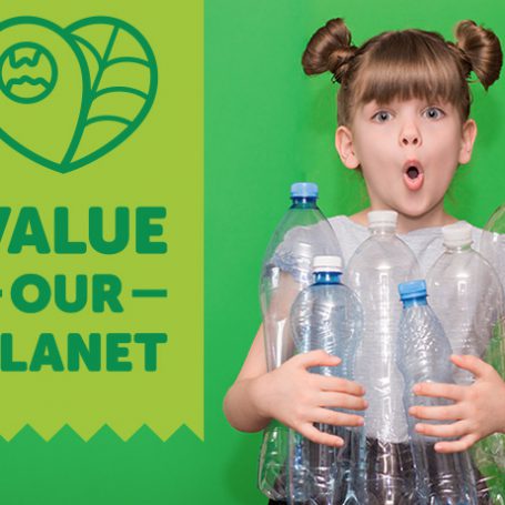 Value our planet sign next to a young girl holding an armful of plastic bottles with a shocked facial expression