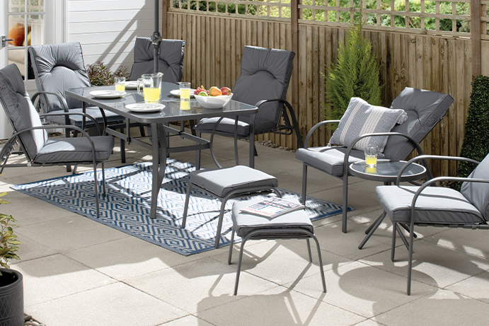 A set of grey textilene and metal garden furniture on a patio