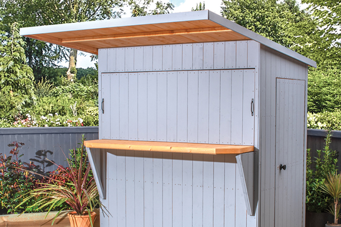 An outdoor bar shed painted in a light grey colour with door and hatched closed