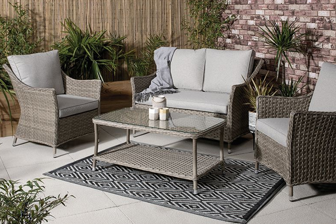 grey rattan sofa and armchair set in an outdoor patio setting