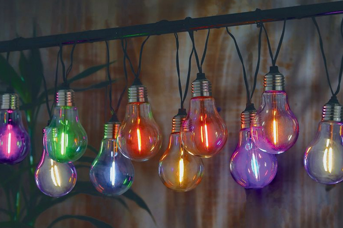 brightly coloured glowing light bulb shaped solar string lights